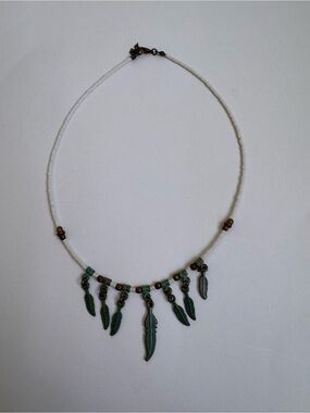 White Beaded Necklace with Green Feather Charms
